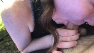 Redhead sucks big cock in the woods