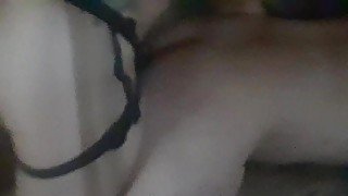 Wife pegging husband bent over on couch