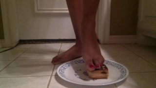 Tgirl crushes a chocolate donut under her foot