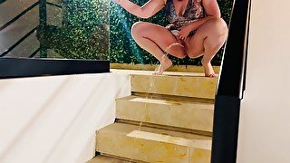 MILF pissing down the stairs