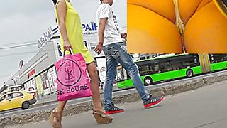 Hot upskirts with slender brunette in yellows dress