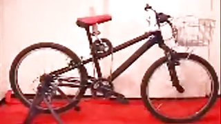 Asian girl tests out the dildo bicycle