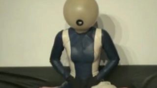 Girl With Transparent Latex Ballhood And Rubber Sheet Makes Breath Play