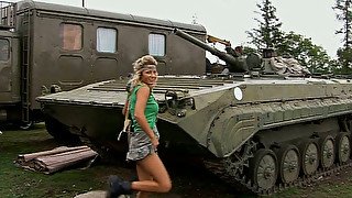 Big tittied blonde hottie strips on a hood on military jeep