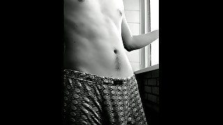 bearded smoker.  handsome guy in shorts.  black and white