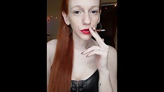 red hair in a high ponytail, smoking in a leather corset