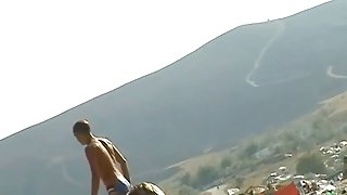 Nude beach cam catches slim blonde oiling her hot body