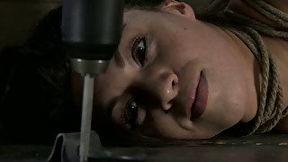 Fixed with ropes in weird pose poor all nude brunette lies on the floor