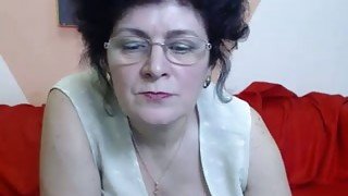 Mature brunette strips and fingers her snatch in webcam show