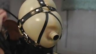 Latex loving mistress puts her maid in a hood