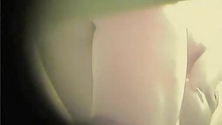 Amateur female leaning towards the spy camera in change room