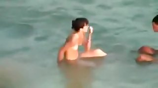 Hidden cam video with a slim brunette getting fucked on a beach