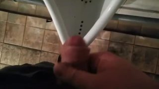 Jerking off in a public toilet