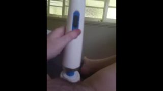 Hitachi by the window while the people are in the yard next door,