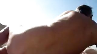 old couple playing on the nude-beach