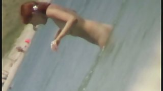 Beach spy cam catches a readhead girl running into the water