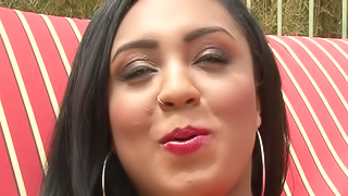 A black woman that has red lingerie on is naked outside in the sun