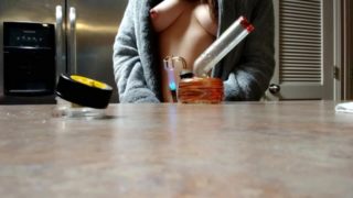 Stoner babe smokes with tits out!