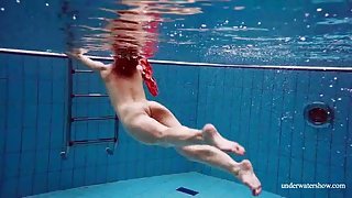 Teen swimming in her red satin prom dress